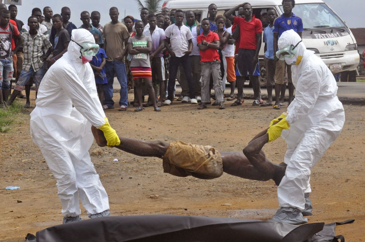 Health workers in Liberia place a man suspected of dying from Ebola into a body bag in September. All the international attention brought to the region has improved public health in these countries: safer burial practices, better disease control, more health facilities and better public awareness about Ebola, the World Bank report said. <a href="http://www.cnn.com/2014/09/16/health/obama-ebola/">The United States pledged</a> more than $750 million to fight the disease. It sent troops, supplies and additional aid to West Africa. But it soon had its own concerns at home.