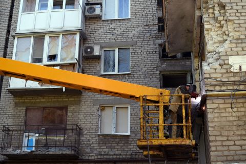 A man repairs damage to a building caused by shelling in Donetsk on September 5. 