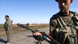 A pro-Russian separatist holds a destroyed weapon on a road in the village of Novokaterinovka, about 30 miles southeast of Donetsk, eastern Ukraine, on Friday, September 4.