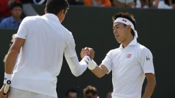 Canada's Milos Raonic (L) shakes hands with Japan's Kei Nishikori (R) at the net after Raonic won their men's singles fourth round match on day eight of the 2014 Wimbledon Championships at The All England Tennis Club in Wimbledon, southwest London, on July 1, 2014. Raonic won 4-6, 6-1, 7-6, 6-3. AFP PHOTO / ANDREW COWIE - RESTRICTED TO EDITORIAL USE (Photo credit should read ANDREW COWIE/AFP/Getty Images)