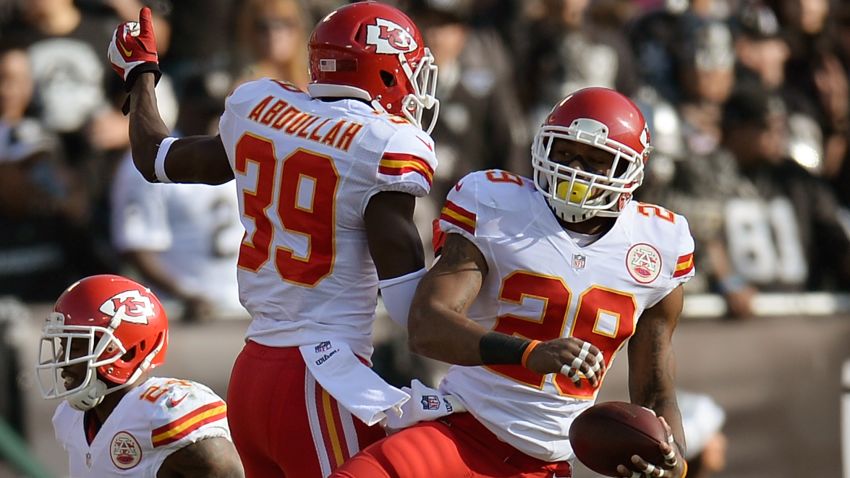 Eric Berry #29 and Husain Abdullah #39 of the Kansas City Chiefs celebrates after Berry returned an interception for a touchdown against the Oakland Raiders during the first quarter at O.co Coliseum on December 15, 2013 in Oakland, California.
