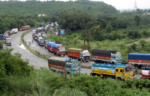 Trucks stranded by flash flooding wait for the Jammu-Srinagar national highway to open on the outskirts of Jammu, India, on September 5. 