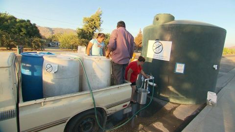 The Gallegos family refills drums with nonpotable water from the county.