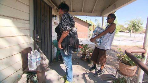 Donna Johnson, left, and a helper go door-to-door.