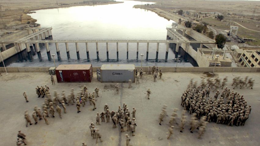 Caption:HADITHA, IRAQ: Marines from the first Battalion 23rd Marines gather in the Haditha's dam deck 250 kms northwest from Baghdad to listen to Brigadier General James L Williams, Commanding 1st Marine Expeditionary Force (MACE) who paid a visit to this base 19 February 2005. US senator Hillary Clinton, wife of former president Bill Clinton, was in Baghdad as part of a delegation from the US Congress led by Senator John McCain that met Iraqi and US military leaders. AFP PHOTO / JAIME RAZURI (Photo credit should read JAIME RAZURI/AFP/Getty Images)