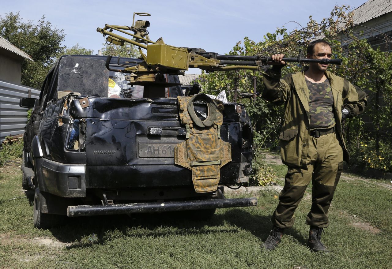 A pro-Russian rebel stands next to a truck with a heavy machine gun attached to it Sunday, September 7, in Donetsk.