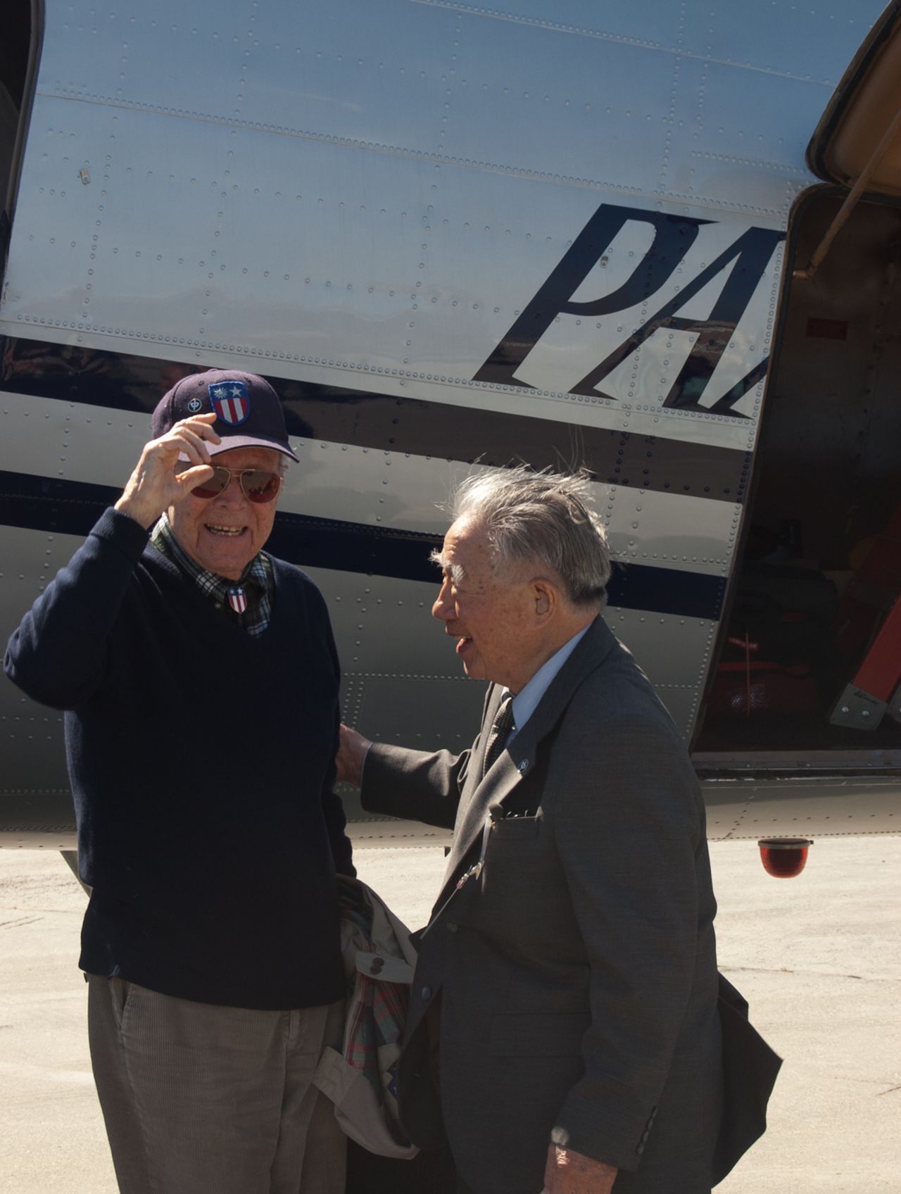 Peter Goutiere, 99, and fellow China National Aviation Corp pilot Moon Chin, 102, greet each other in San Francisco.
