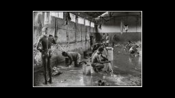 No known caption (According to Struan Robertson, washing conditions at the mines were primitive. Shower rooms were crowded with men trying to bathe while others did their meager laundry.)
