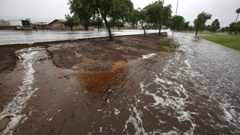 Floodwaters wash away a Phoenix sidewalk on September 8. 