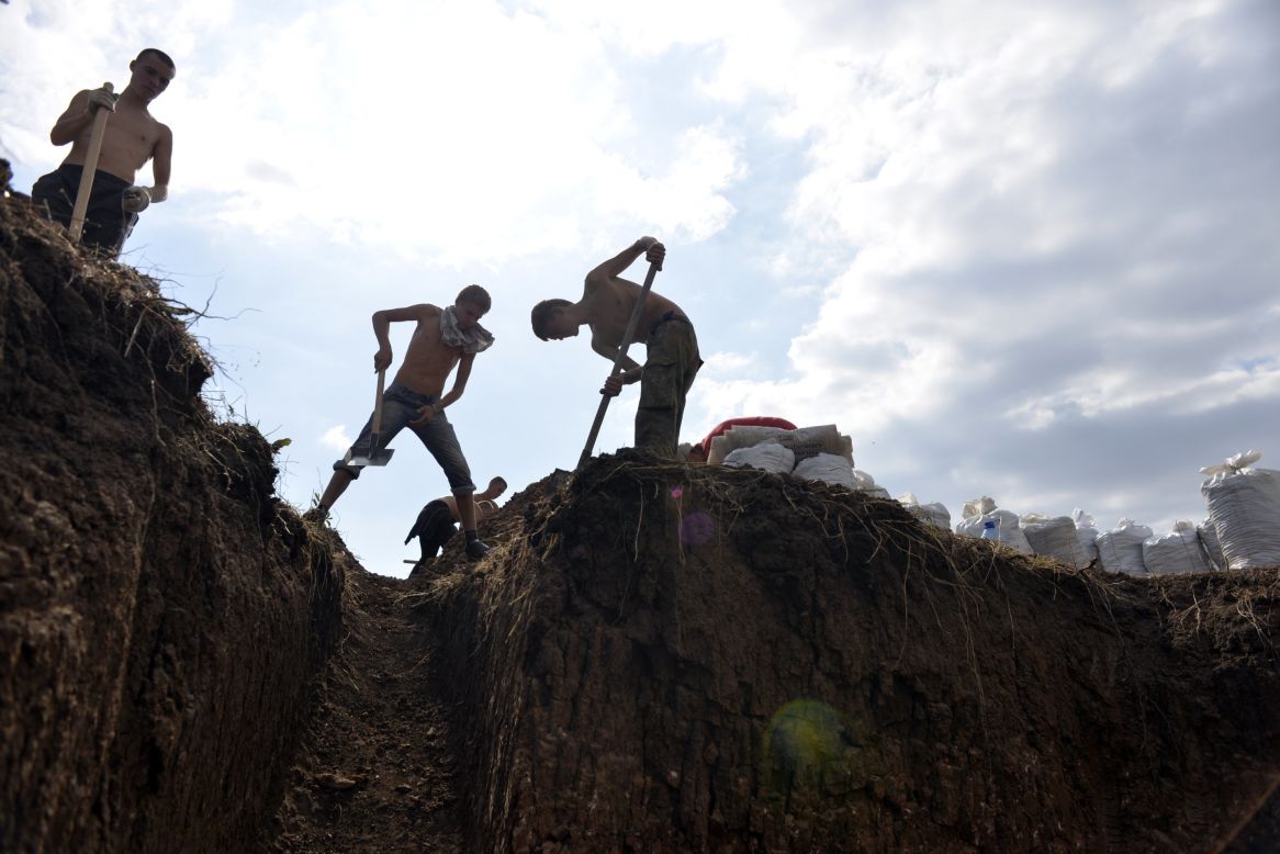 Young residents of Berdyansk, Ukraine, dig trenches September 9 to help Ukrainian forces protect the city from possible rebel attacks. 