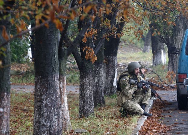 Ukrainian troops protect themselves from a nearby shooting in Debaltseve on Tuesday, September 9. 