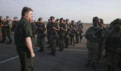 Ukrainian President Petro Poroshenko, left, inspects military personnel during a visit to Mariupol on Monday, September 8.