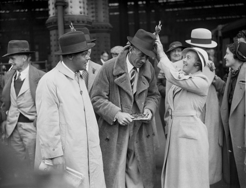 Players' wives and girlfriends have always been a part of the Ryder Cup, but their role has become more prominent as time has gone on. Here, Alf Padgham's wife lodges a sprig of lucky heather in her husband's hat at Waterloo station in London before the Great Britain team departed for the 1935 Ryder Cup in New Jersey.