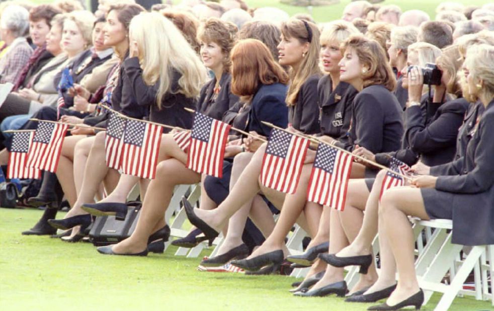 Wives and girlfriends of the United States Ryder Cup team hold American flags during the opening ceremonies of the 1995 Ryder Cup at the Oak Hill Country Club.