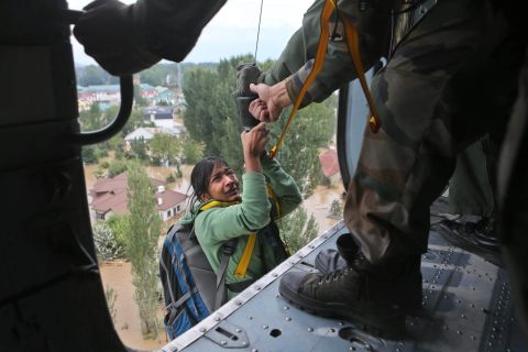 A tourist cries as she is airlifted into a chopper in Srinagar on September 9.