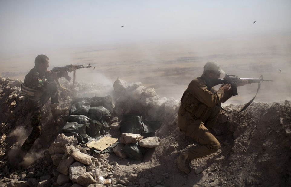 Kurdish Peshmerga fighters fire at ISIS militant positions from their position on the top of Mount Zardak, east of Mosul, Iraq, on Tuesday, September 9.