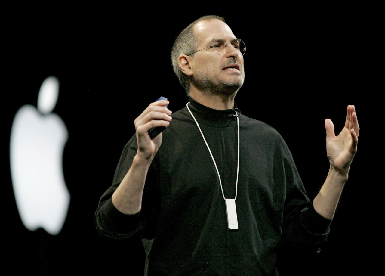Apple co-founder and CEO Steve Jobs introduces the iPod Shuffle, which rolled out in 2005. Considered an "entry-level" iPod, it was small but gave up some storage space in return and less expensive than previous models. Designed for exercise and other uses on the go, it came with a lanyard, and accessories included an armband and waterproof case. The latest model comes with a clip and costs just $49.