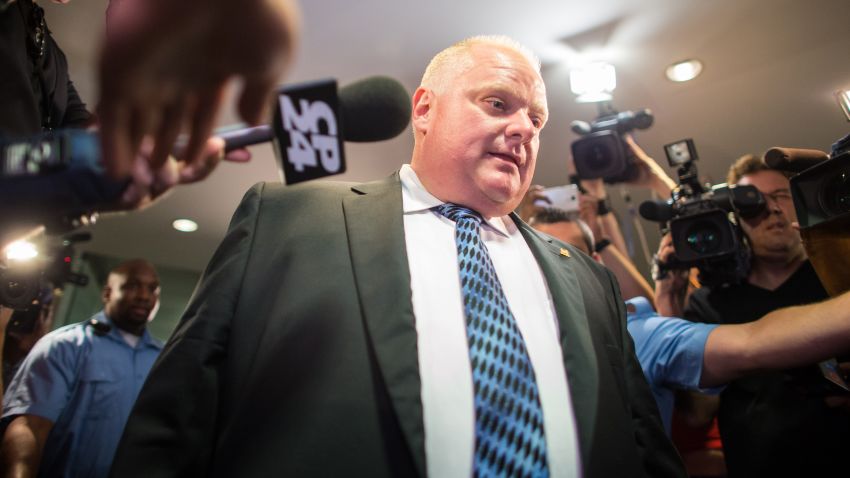 Toronto Mayor Rob Ford leaves his office at city hall in Toronto on June 30 amid a crush of cameras. Ford returned to work more popular than ever after a stint in rehab for his internationally publicized alcohol and drug abuse.