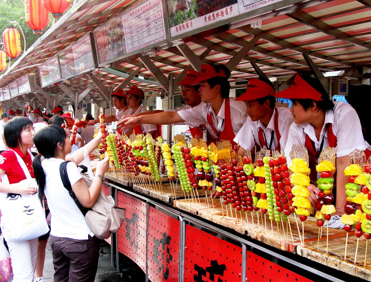 Skewers of sweet pineapple, tart green grapes, and other colorful arrangements of fruit line a concession stand in<a href="http://ireport.cnn.com/docs/DOC-1156894"> Beijing, China</a>.