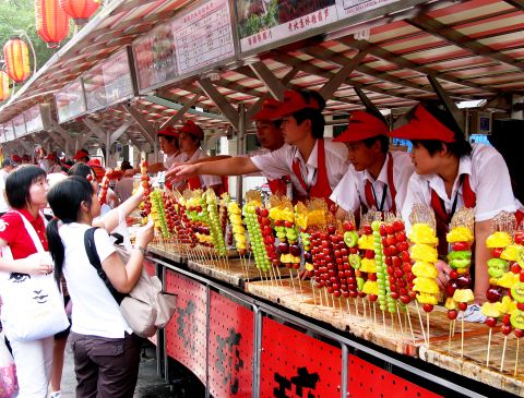 Skewers of sweet pineapple, tart green grapes, and other colorful arrangements of fruit line a concession stand in<a href="http://ireport.cnn.com/docs/DOC-1156894"> Beijing, China</a>. 