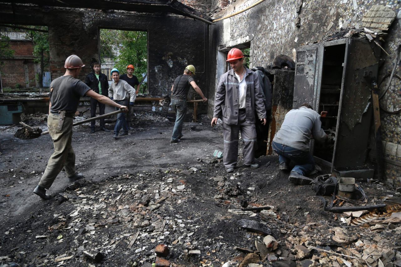 Workers clear rubble Thursday, September 11, after the bombing of a mine in Donetsk.