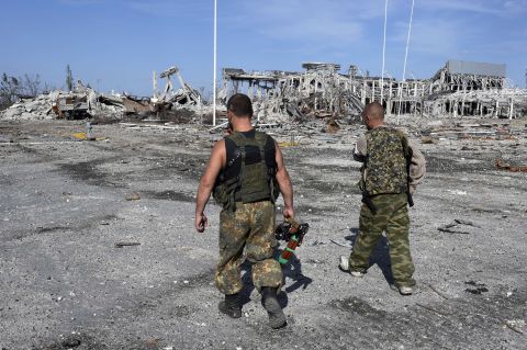 Armed pro-Russian rebels walk September 11 in front of the destroyed Luhansk International Airport. The rebels took control of the airport on September 1 after heavy fighting with the Ukrainian army. 