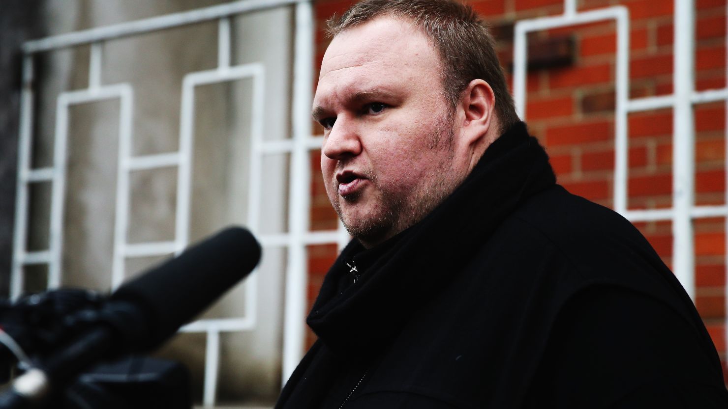 Kim Dotcom talks to media after casting his advance vote in the 2014 general NZ election in Auckland on September 3.