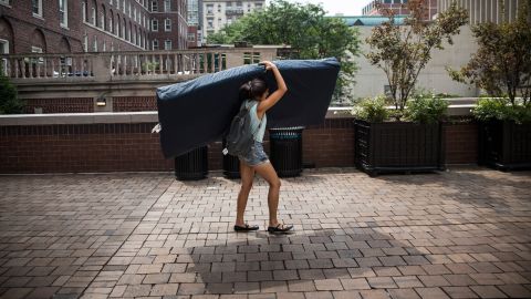 Emma Sulkowicz of Columbia University carries a mattress in protest of the university's lack of action after she reported being raped.
