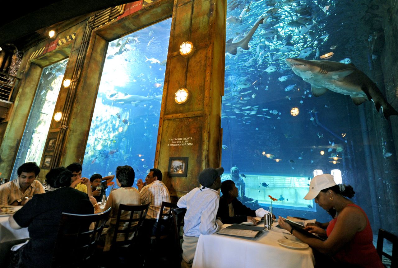 One of uShaka's attractions is the Cargo Hold restaurant, where diners eat while sharks look on, possibly licking their lips.