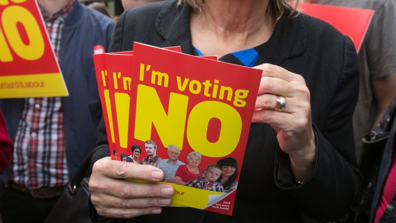 People in Edinburgh, Scotland, hold leaflets September 12 campaigning against independence.