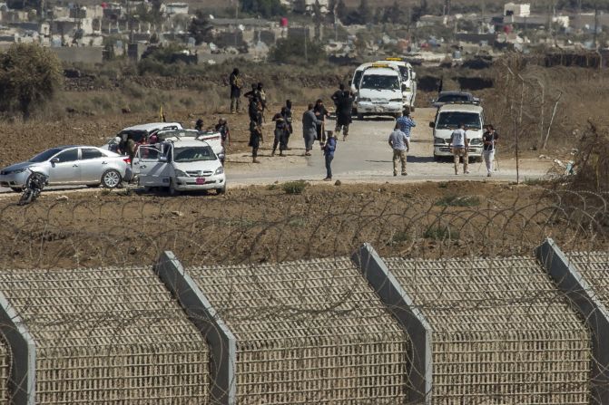 Al-Qaeda-linked rebels from Syria gather around vehicles carrying U.N. peacekeepers from Fiji before releasing them Thursday, September 11, in the Golan Heights. The 45 <a href="index.php?page=&url=http%3A%2F%2Fwww.cnn.com%2F2014%2F09%2F01%2Fworld%2Fmeast%2Fsyria-crisis%2Findex.html" target="_blank">peacekeepers were captured </a>in the Golan Heights after rebels seized control of a border crossing between Syria and the Israeli-occupied territory.