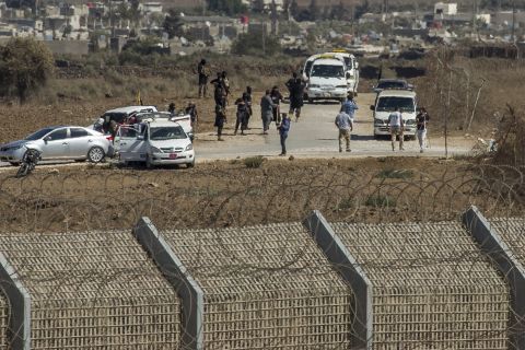 Al-Qaeda-linked rebels from Syria gather around vehicles carrying U.N. peacekeepers from Fiji before releasing them Thursday, September 11, in the Golan Heights. The 45 <a href="http://www.cnn.com/2014/09/01/world/meast/syria-crisis/index.html" target="_blank">peacekeepers were captured </a>in the Golan Heights after rebels seized control of a border crossing between Syria and the Israeli-occupied territory.