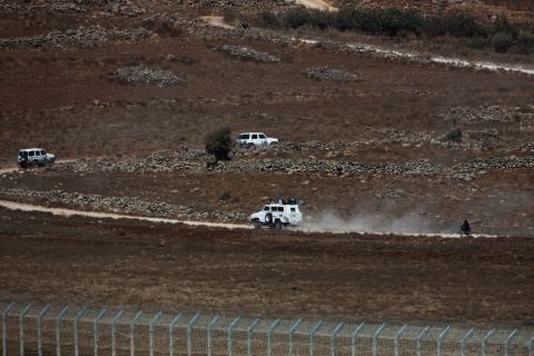 A U.N. convoy moves in the buffer zone near the Golan Heights as they are escorted by Syrian rebel fighters near the Syrian village of Jubata Al Khashab on Tuesday, September 2.