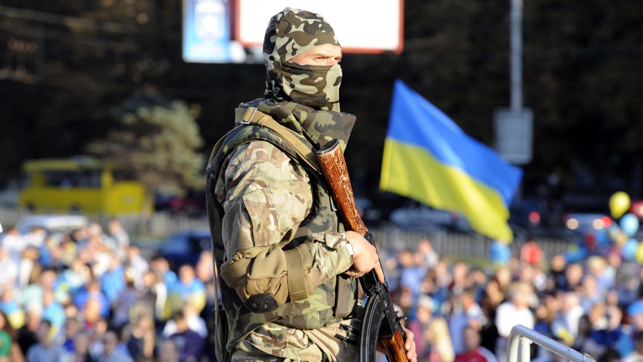 A Ukranian soldier stands gurad as residents rally in support of a united Ukraine in the southern Ukrainian city of Mariupol, on September 13.