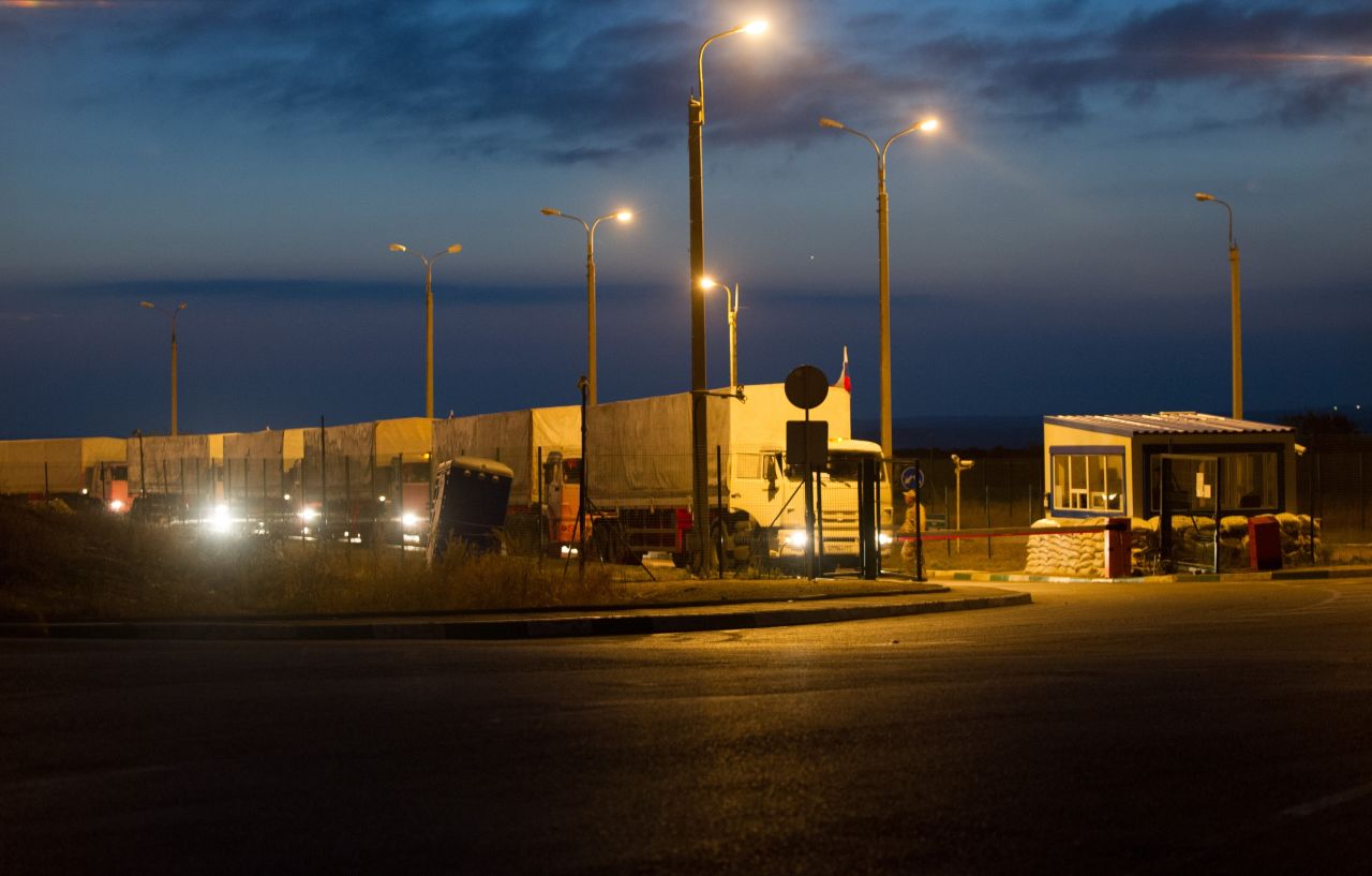 Russian trucks, flying Russian flags and carrying humanitarian aid for eastern Ukraine, line up at a border checkpoint in Donetsk on September 13.