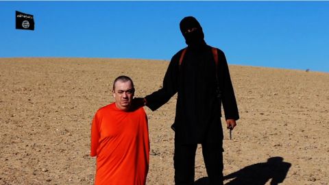 Alan Henning with an ISIS member in a frame taken from a video released by ISIS. 