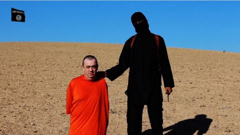 Alan Henning with an ISIS member in a frame taken from a video released by ISIS.