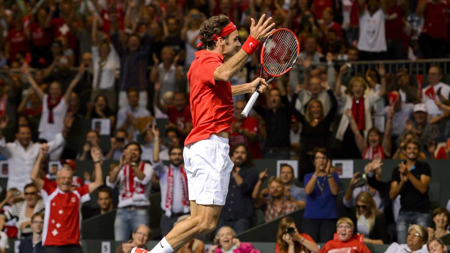 Roger Federer jumps for joy after completing his singles victory over Fabio Fognini in the Davis Cup semifinal.