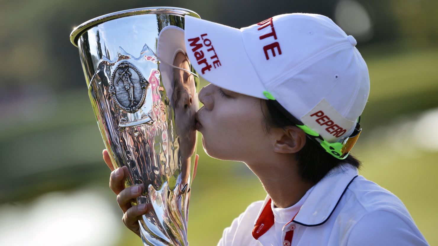 Hyo-Joo Kim kisses the Evian Championship trophy after claiming her first major in dramatic style.