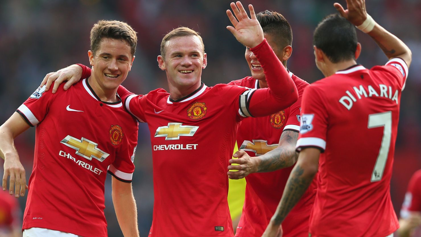 Manchester United stars celebrate Wayne Rooney's third goal in the 4-0 win over QPR at Old Trafford.