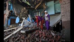 Women salvage what they can from their house which was destroyed during the flooding in Chak, India, on Monday, September 15.