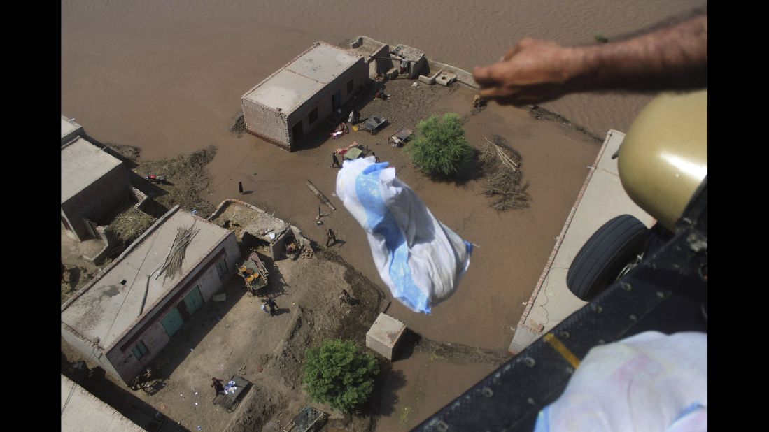 A Pakistani soldier drops relief goods in the flooded city of Multan, Pakistan, on Sunday, September 14.