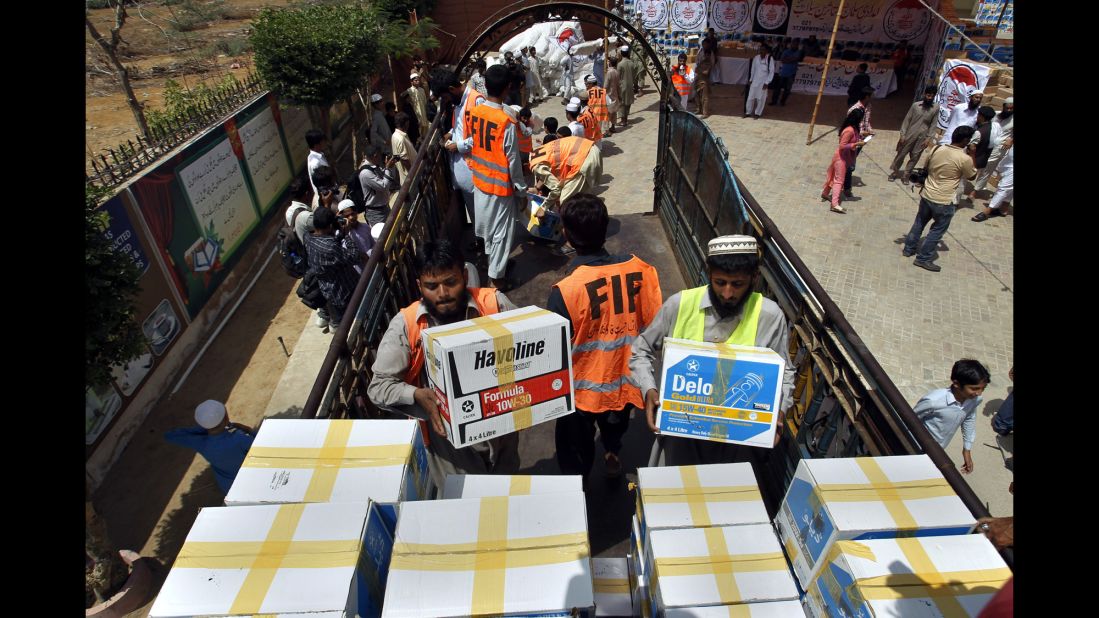 Members of a charity group load relief goods onto a truck in Karachi, Pakistan, on September 14.