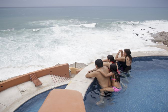 Tourists watch the ocean from inside a swimming pool at a resort in Los Cabos on September 14.