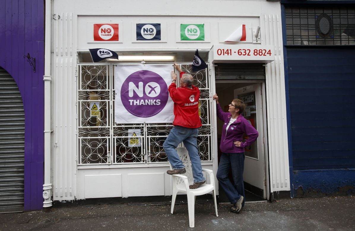 A man hangs a banner on a "Better Together" campaign office in Glasgow on September 15.