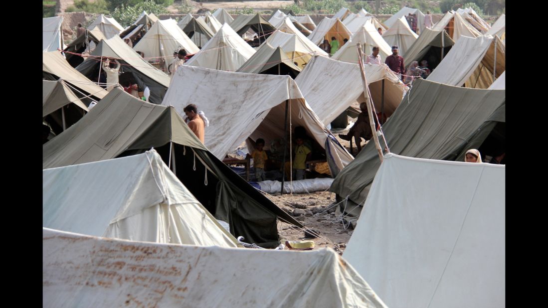 People walk around a relief camp set up by the Pakistani government on the outskirts of Multan.
