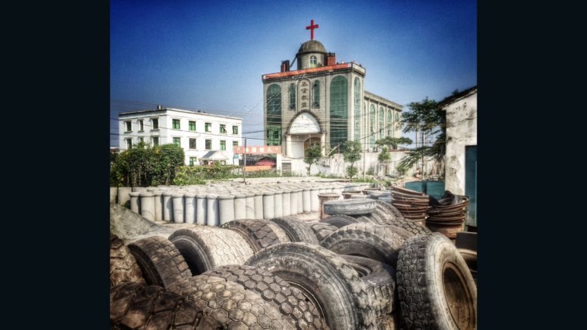 A red cross stands on top of a gray Christian church in Pingyang County in Wenzhou. Local faithful have guarded the church compounded for more than two months after officials ordered the removal of the cross.