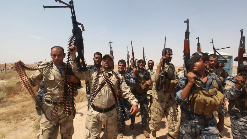 Volounteers who joined the Iraqi army to fight against Jihadist militants of the Islamic State (IS) brandish their weapons as they come as backup at a checkpoint in the city of Diyala, north of the capital Baghdad, on July 23, 2014. Iraqi government air strikes against jihadists, some with the use of barrel bombs, have killed at least 75 civilians since the start of June, Human Rights Watch said. AFP PHOTO / AMER AL-SAEDI (Photo credit should read AMER AL-SAEDI/AFP/Getty Images)