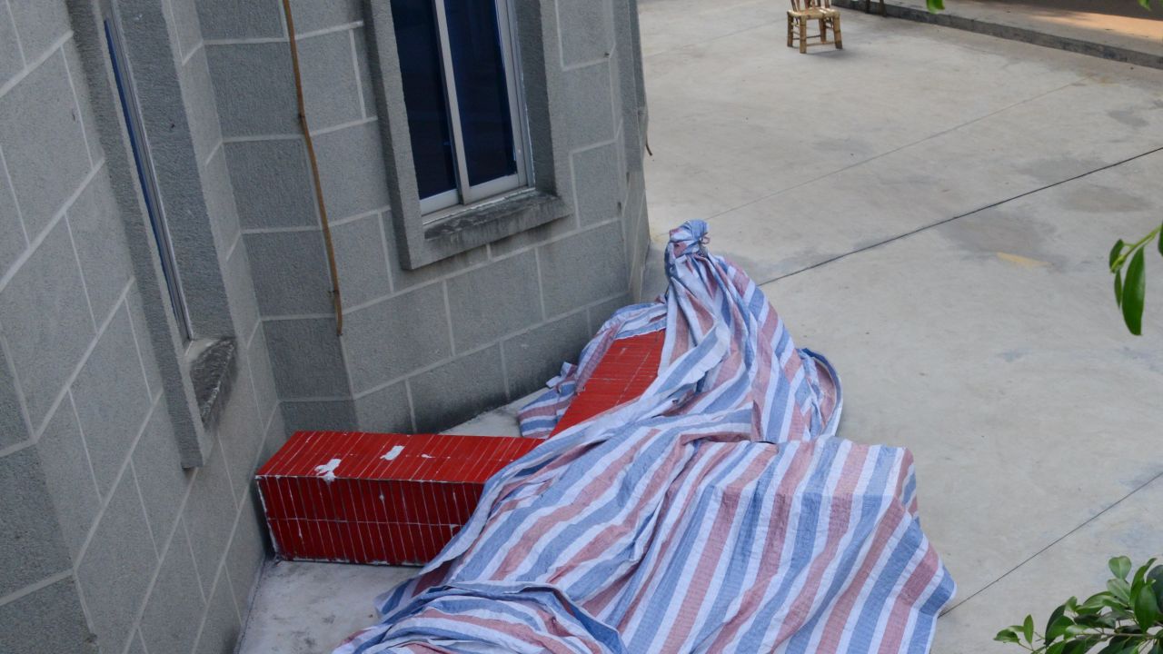 The cross now lies under a cheap plastic tarpaulin at the foot of the church's stairs.