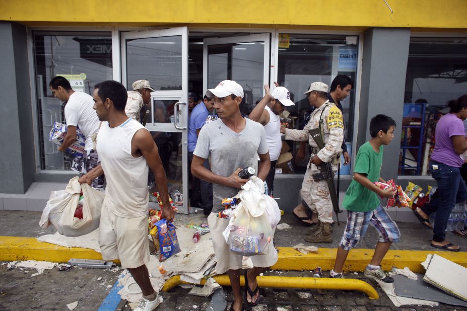 People take items from a Los Cabos convenience store that was destroyed by Hurricane Odile on September 15.